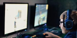 The Social Nature of the Modern Gamer boy wearing headset playing computer game