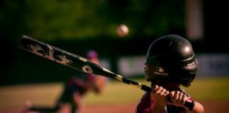 5 Tips for Playing Baseball in the Summer selective focus photography of person holding baseball bat