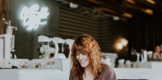 UK Online Casinos woman sitting on brown wooden chair while using silver laptop computer in room