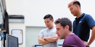 The Advantages of IT Outstaffing man in maroon long sleeve shirt holding a book