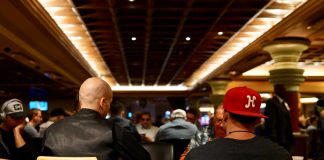 7 Top Tips to Rising to a Top Poker Player man in black crew neck shirt wearing red cap sitting on chair