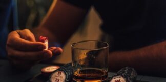 How to Play Sit and Go Poker Tournaments person holding clear drinking glass