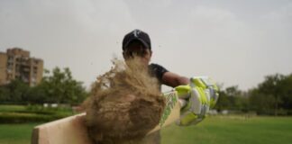 How to Bet on Sports in Cyprus With Parimatch man in black t-shirt and black cap holding brown skateboard