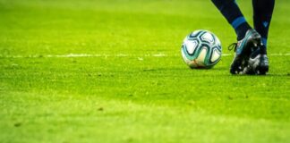 How to Read Football Odds: A Beginner’s Guide man playing soccer game on field