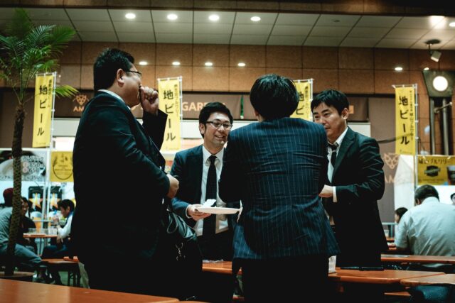 Photo by Christian Chen group of people standing in front of brown wooden table
