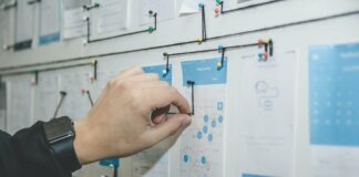 Contract Management Trends & Predictions for 2023 person working on blue and white paper on board