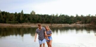 From Casual to Committed: The Journey of Relationships on Dating Platforms Couple Wearing Grey T-shirts Walking on Shallow Water and Smiling