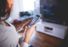 The Latest Trends and Innovations in Smart Home Technology and How To Use Them Woman Wearing White V Neck Shirt Using Space Gray Iphone 6