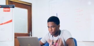 Top Trading Sites for Popular Game Titles man in grey shirt using grey laptop computer