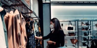 A Timeless Quest – Curating a Wardrobe that Speaks Volumes for Women Everywhere woman in black long sleeve shirt standing in front of clothes