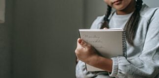 How to Write an Essay and Achieve Higher Grades Crop unrecognizable girl in casual outfit sitting on chair and taking notes in copybook