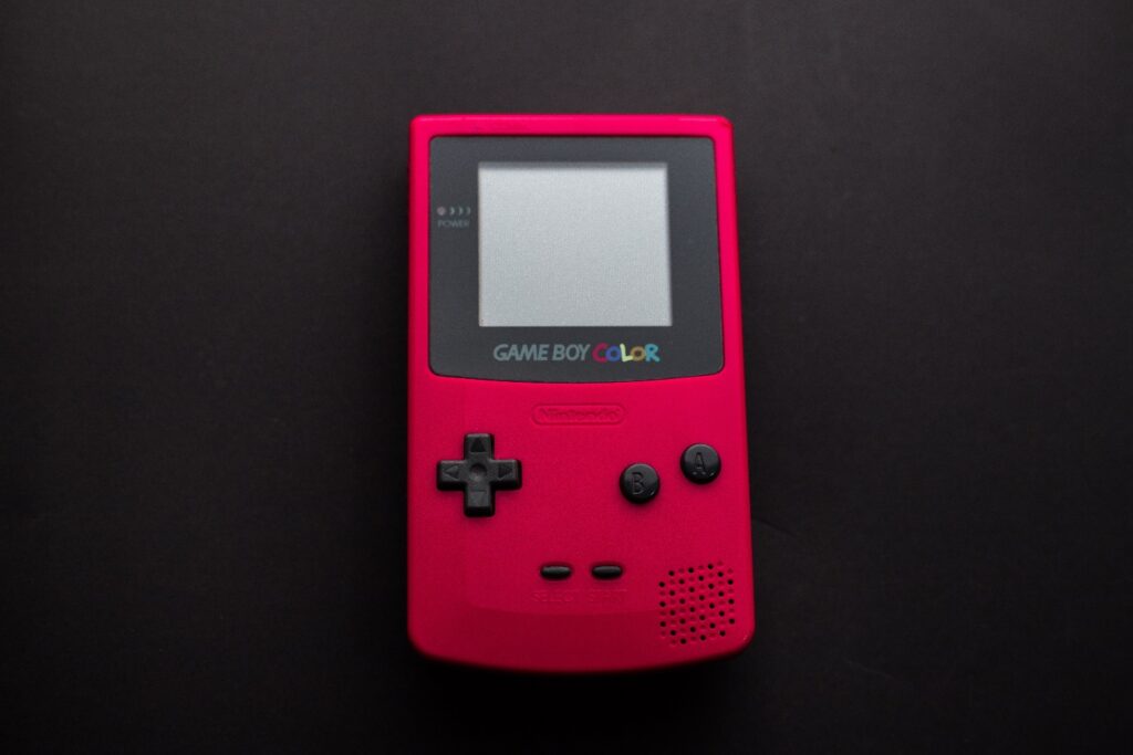 A pink handheld game console Description automatically generated