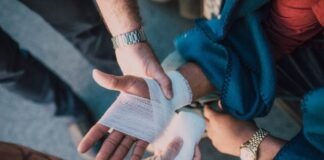 Can I Still Pursue a Personal Injury Claim if I Was Partially at Fault for the Accident? Person Applying Bandage on Another Person's Hand