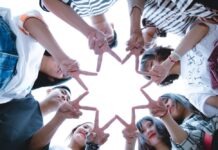 Mindful Team Building: Incorporating Online Games for Remote Employee Well-Being Group of People Forming Star Using Their Hands