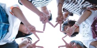 Mindful Team Building: Incorporating Online Games for Remote Employee Well-Being Group of People Forming Star Using Their Hands