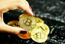 Critical Legal Aspects of Bitcoin: A Definitive Manual gold round coin on persons hand