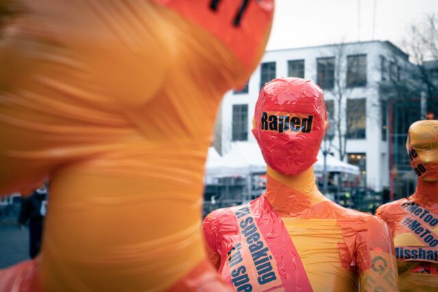 Photo by Mika Baumeister man in orange crew neck shirt