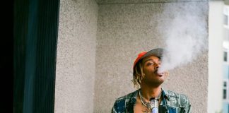 What a Bong Says About Your Stoner Priorities a man smoking a cigarette next to a potted plant