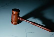 Why ‘Just Pleading Guilty’ Could Ruin Your Life (Even for ‘Small’ Charges) a wooden judge's hammer sitting on top of a table