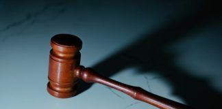 Why ‘Just Pleading Guilty’ Could Ruin Your Life (Even for ‘Small’ Charges) a wooden judge's hammer sitting on top of a table