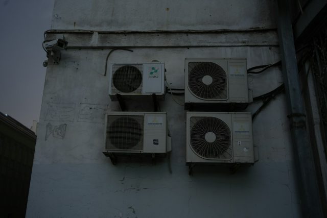 Photo by nikita yudaev A group of speakers mounted to the side of a building