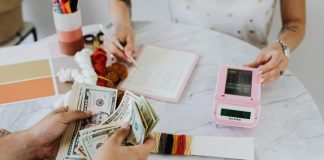 Key Steps In The Financial Restructuring Process A creative workspace featuring a hands-on money counting and budgeting scene.