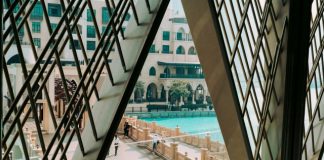 The Hidden Wellness Revolution: How Dubai is Bridging the Gap for European Expats people walking on bridge beside pool in front of building