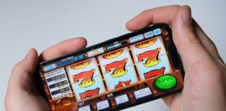 How Slot Game Duration Impacts Platform Margins Someone is playing a mobile slot machine game.
