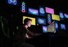 Why Instant Play Matters: The Hidden Influence of Steam’s ‘Click-to-Launch’ Culture A focused gamer plays e-sports in a neon-lit room, surrounded by digital screens.