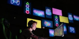 Why Instant Play Matters: The Hidden Influence of Steam’s ‘Click-to-Launch’ Culture A focused gamer plays e-sports in a neon-lit room, surrounded by digital screens.