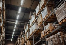 Why Last Mile Delivery Software Has Become Central to Supply Chain Cost Control brown cardboard boxes on white metal rack
