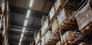Why Last Mile Delivery Software Has Become Central to Supply Chain Cost Control brown cardboard boxes on white metal rack